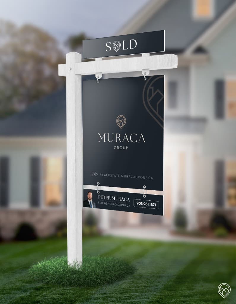 A white listing post with a navy Muraca Group Sold sign and a rider for Peter Muraca, in front of a blurred house.