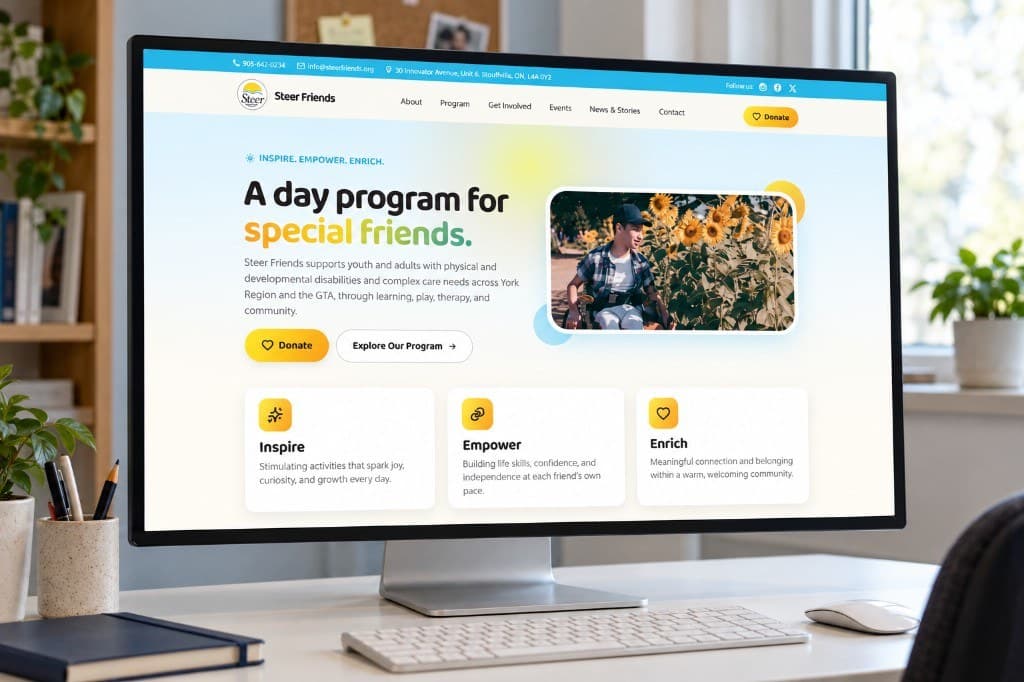 A desktop computer on a white desk showing the Steer Friends homepage: a short heading, a photograph of a person in a sunflower field, and three service cards.