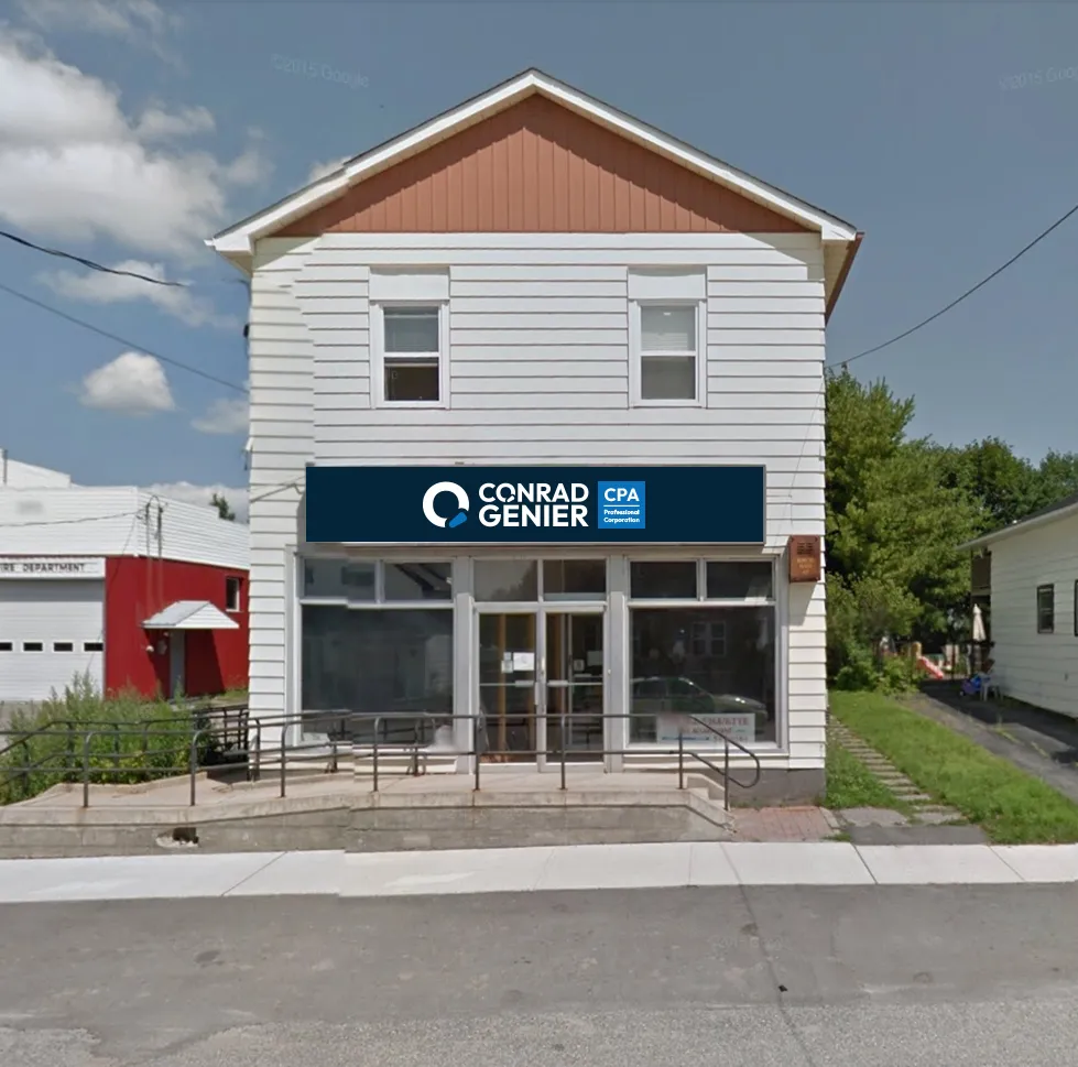 A navy Conrad Genier CPA fascia sign on the front of a white two-storey clapboard building with a street-level storefront.