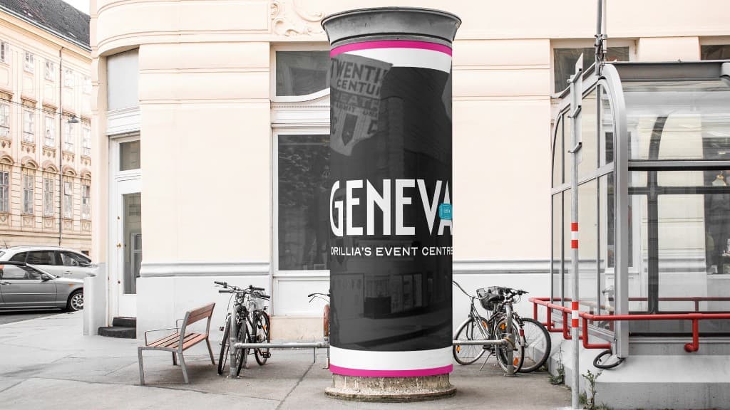 A street advertising column in front of a pale building, wrapped with the black-and-white GENEVA, Orillia’s Event Centre lockup and a magenta edge.