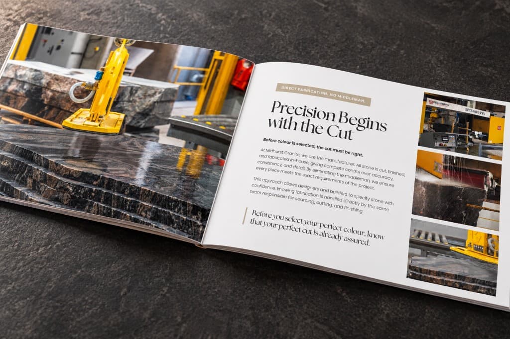 An open Granite Colour Book spread on a dark surface: a slab under a lifting arm on the left, and fabrication photographs beside body copy on the right.