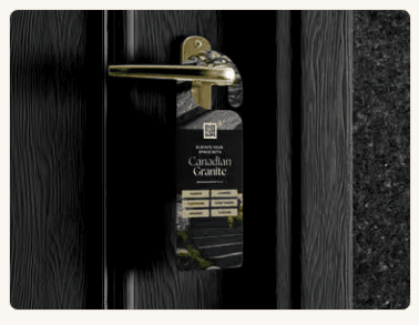 A black Midhurst Granite door hanger on a gold handle of a dark door, reading Canadian Granite, with product buttons and a photograph of a stone walkway.