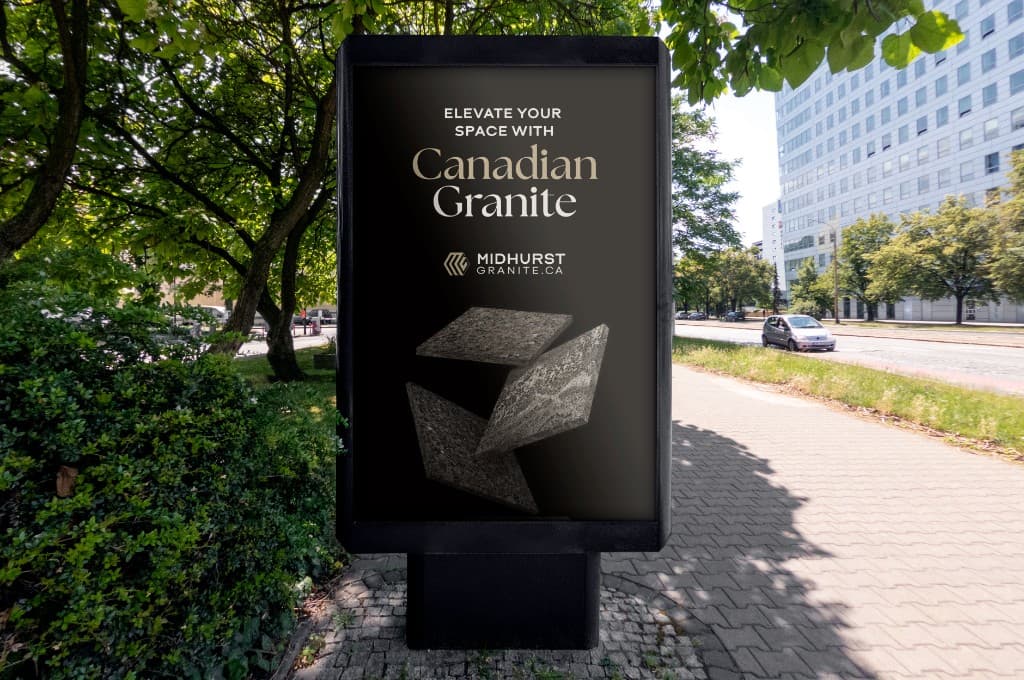 Street-level poster box on a tree-lined sidewalk showing the black Midhurst Granite advertisement: Elevate Your Space with Canadian Granite above the logo and four floating granite slabs.