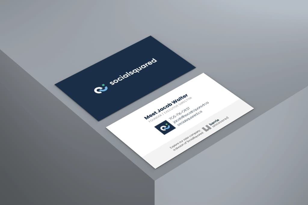 SocialSquared business card: a navy front with the logo, and a white back with the founder's contact details and a line inviting the reader to explore Barrie Uncovered, a division of SocialSquared.
